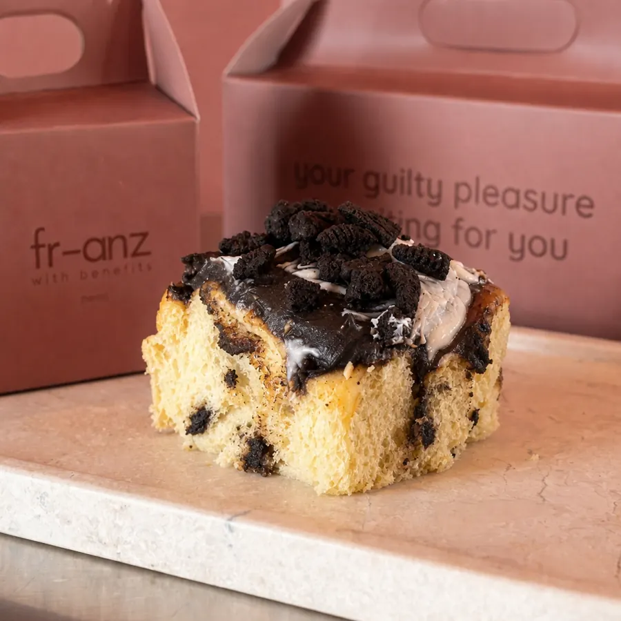 Oreo cinnamon roll with white ganache and Oreo crumbs