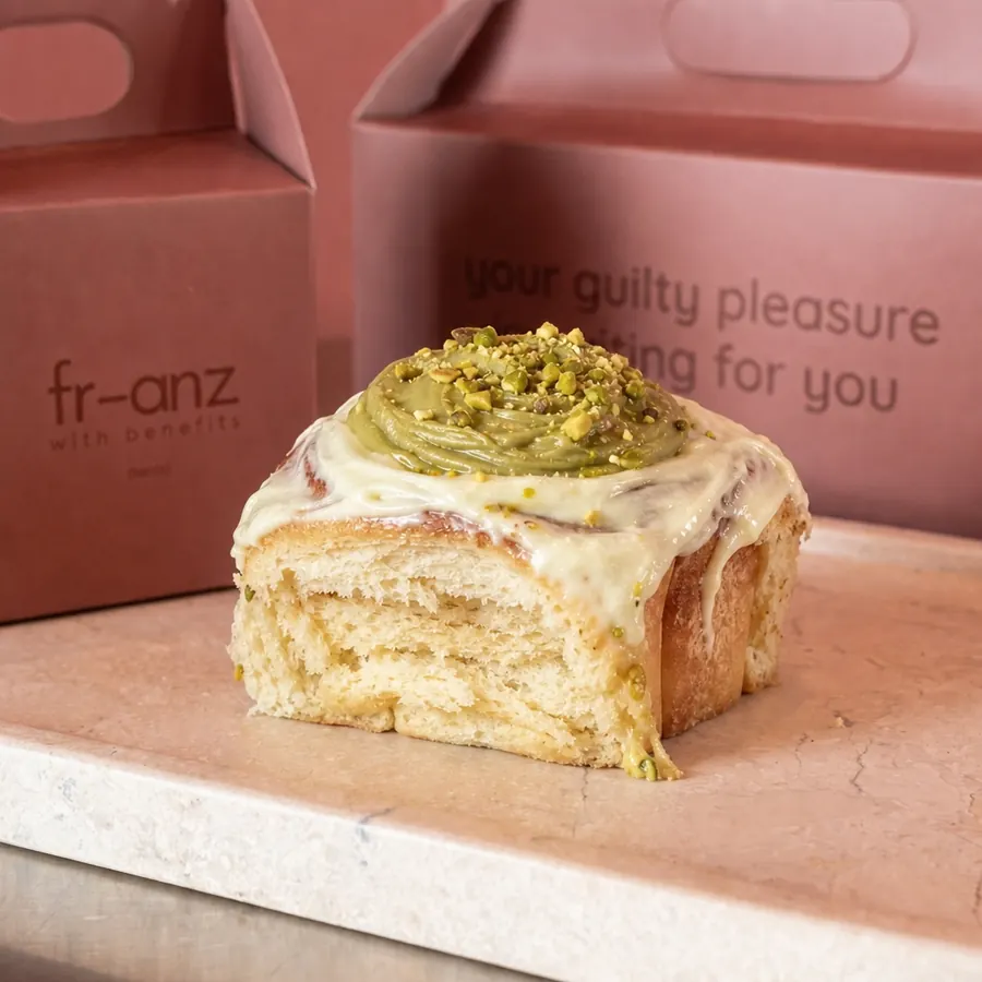Pistachio cinnamon roll topped with pistachio cream and crushed pistachios