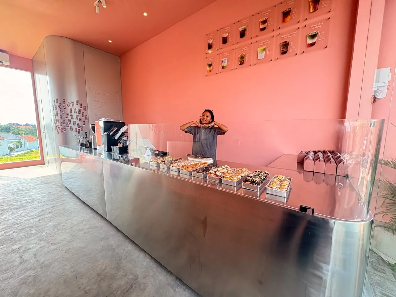 Inside fr-anz: trays of cinnamon rolls under the drinks board