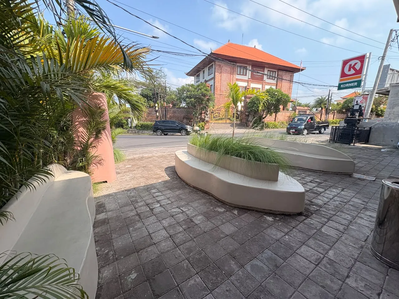 Curved benches and planters in front of the café in Pererenan