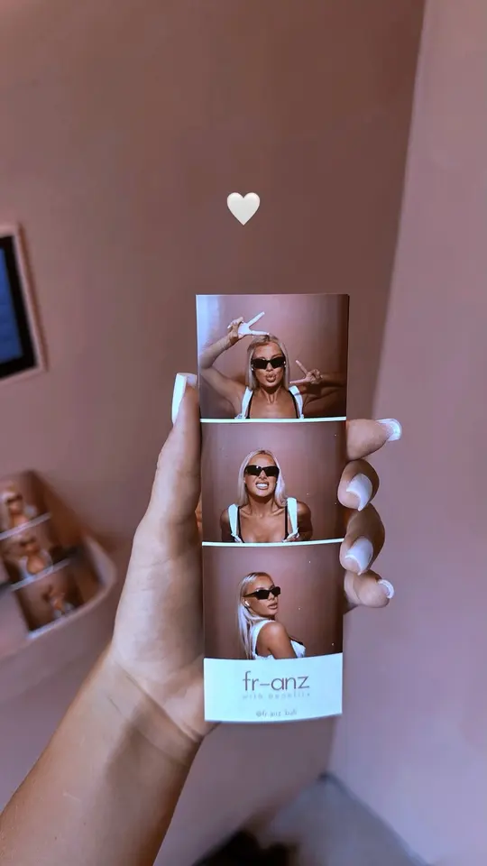 A photobooth strip held up inside the café